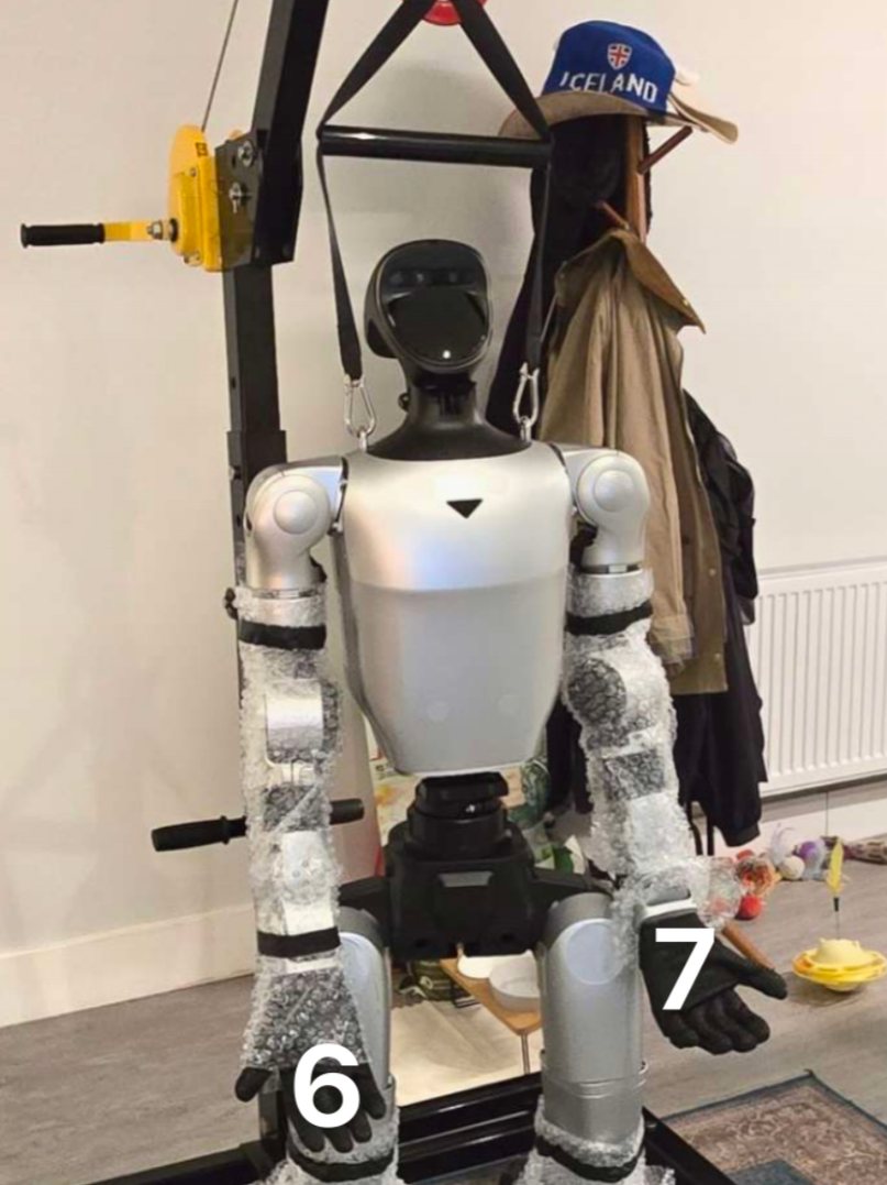 Humanoid robot held on a service rig during a check