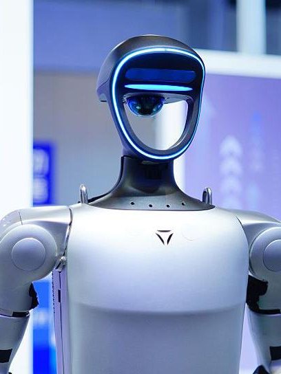 A Unitree humanoid in front of a lit product-launch backdrop