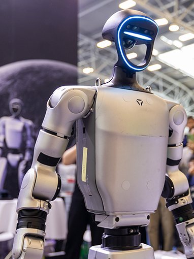 A Unitree humanoid on stage in front of an audience
